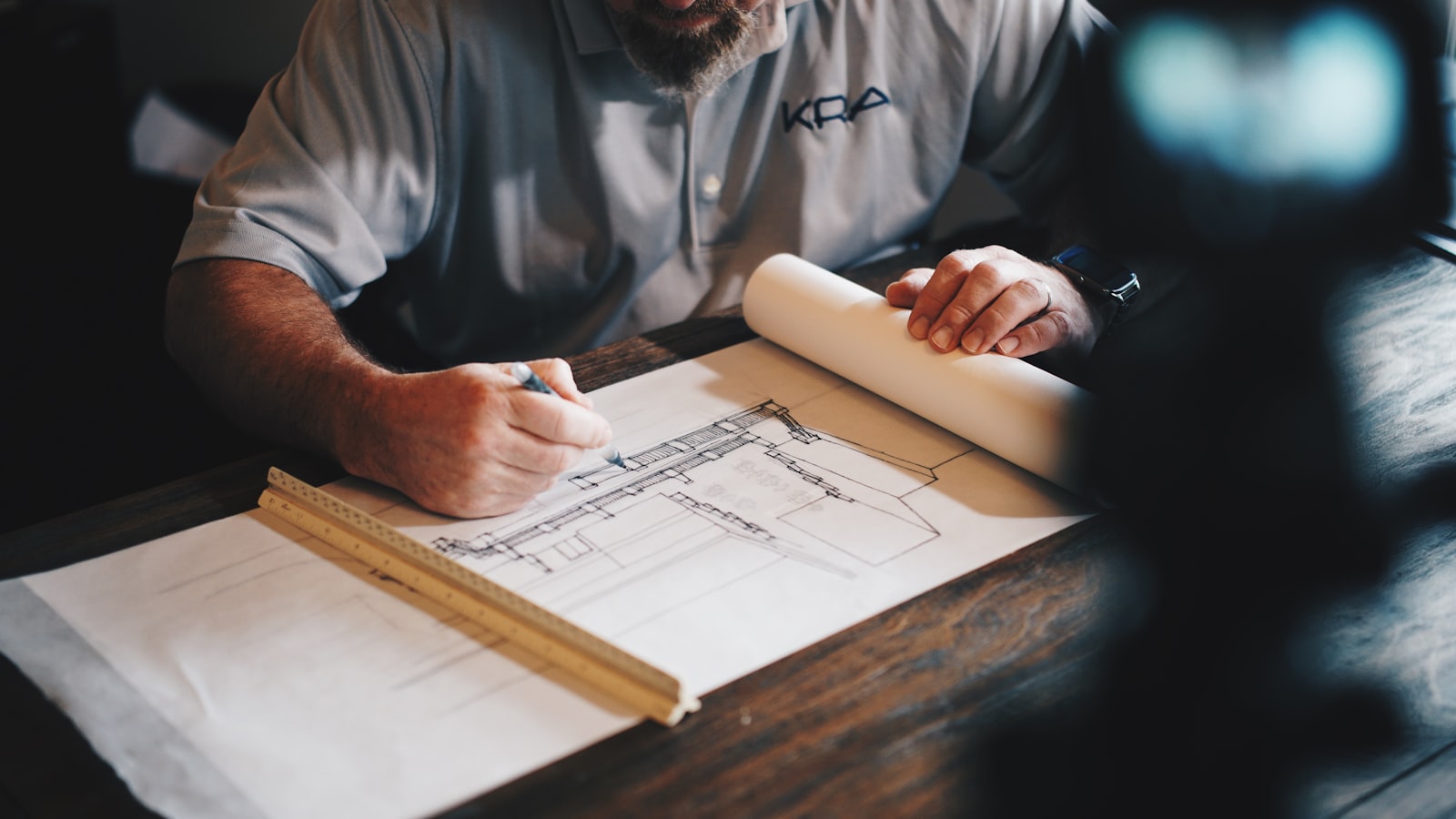 Blueprints and tools on a working table of a real estate project