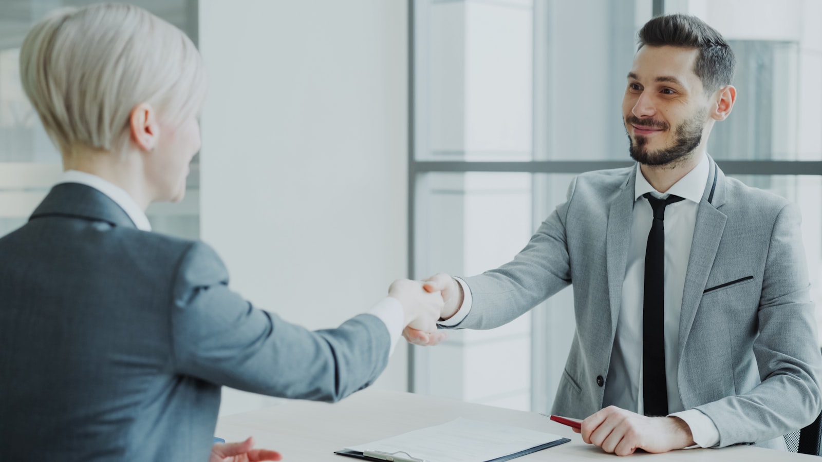 Business professionals shaking hands after a meeting